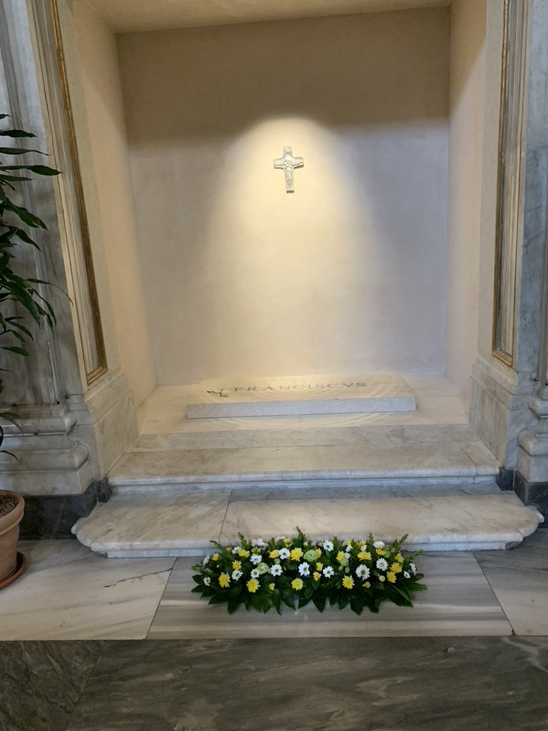 Sacred interior of a church with flowers and a cross — a place of quiet reflection